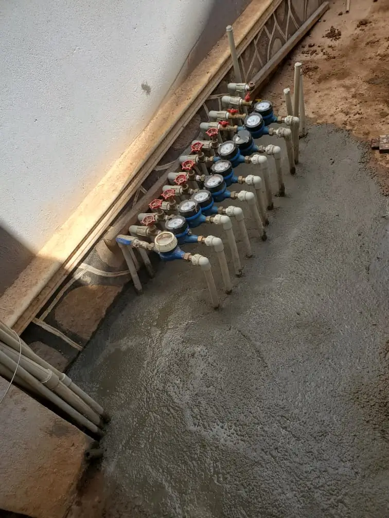 Experienced plumber installing new water pipes in Uganda building
