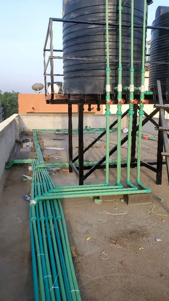 Plumber unblocking clogged drain in residential Kampala property