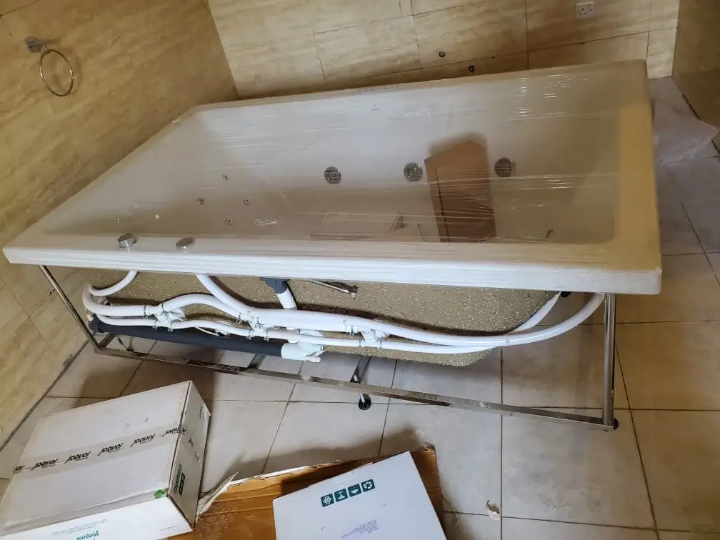 Emergency plumber fixing burst pipe in Kampala